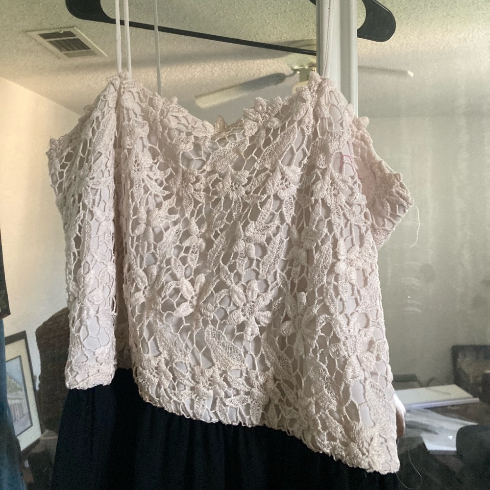 Spaghetti strap crochet lace bodice attached to gathered black jersey skirt.
